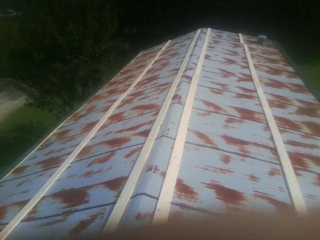 Rusted metal roof panels with new wood purlins before replacement — Storm Damage Roof Repair in Gloucester Point by Roofing Brothers